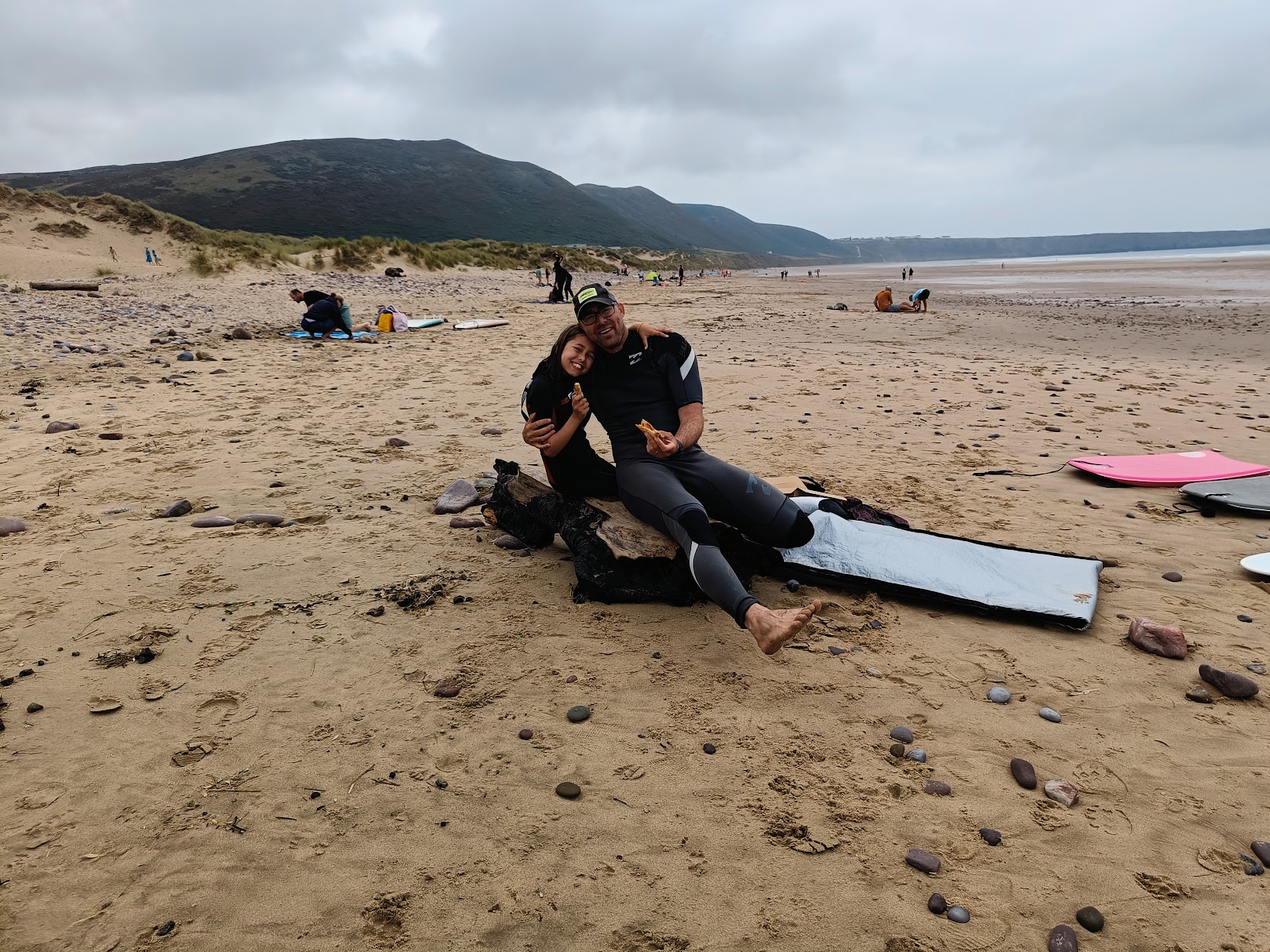 Marc and his wife on a Welsh beach in wetsuits